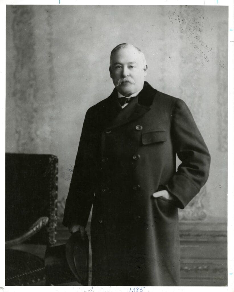 Marcus Daly - 1841 - 1900 (one of the famous Copper Kings; formal portrait in and overcoat; 3/4 body photo). Circa 1895