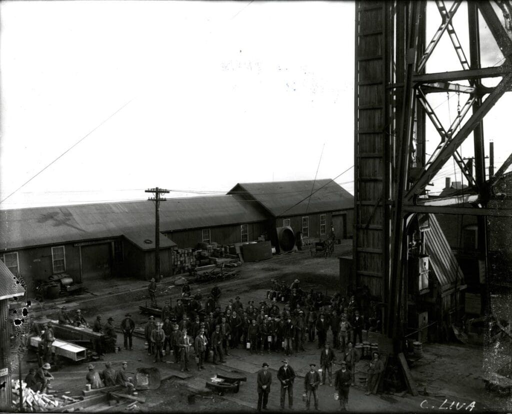 Miners waiting to go on shift at the Anaconda, Mine. Circa 1910 3rd Steel Headframe installed in Butte 1897