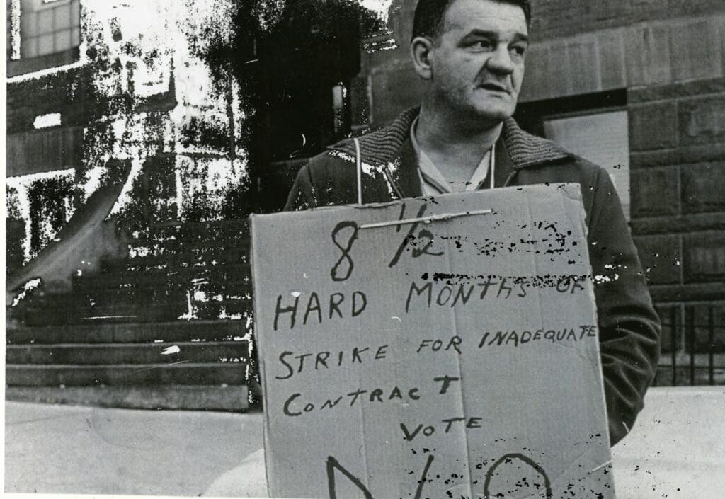 Miners on strike in 1967 in front of the Miner's Union Hall on Granite Street. Butte, MT. Man is identified as Milan Mrkich